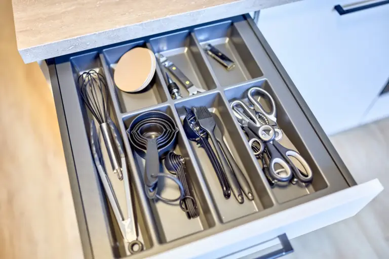 Organized kitchen utensils and cooking tools in a drawer at CORAL SUN
