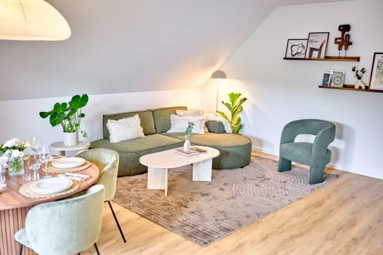 Bright open-concept living and dining area with green furnishings and modern decor in CORAL SUN