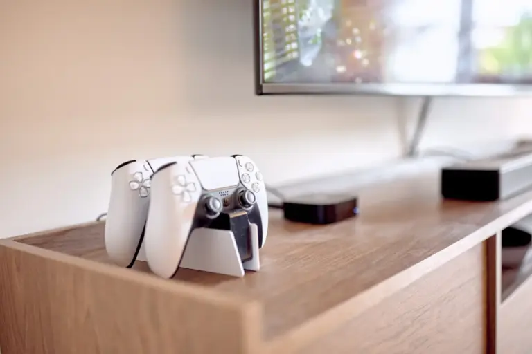 PlayStation 5 DualSense controllers and console beneath the Smart TV in the CORAL SUN living room