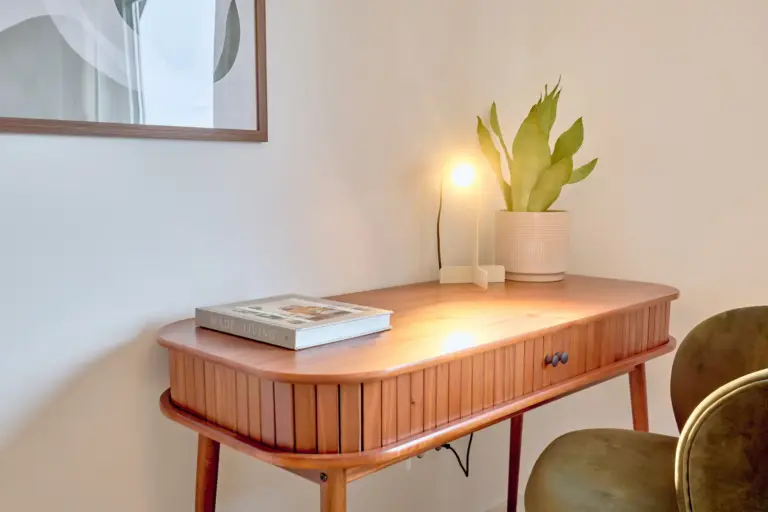 Wooden desk with green chair and modern lamp in CORAL SUN second bedroom