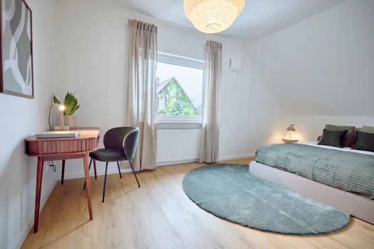 CORAL SUN second bedroom with queen-size bed, desk and green accents
