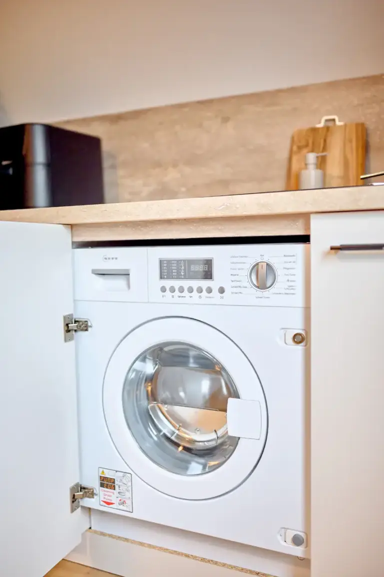 Built-in washer-dryer in the kitchen at CORAL SUN