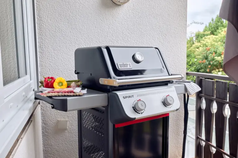 Weber gas grill on the CORAL SUN balcony with side shelves and fresh vegetables prepared for grilling
