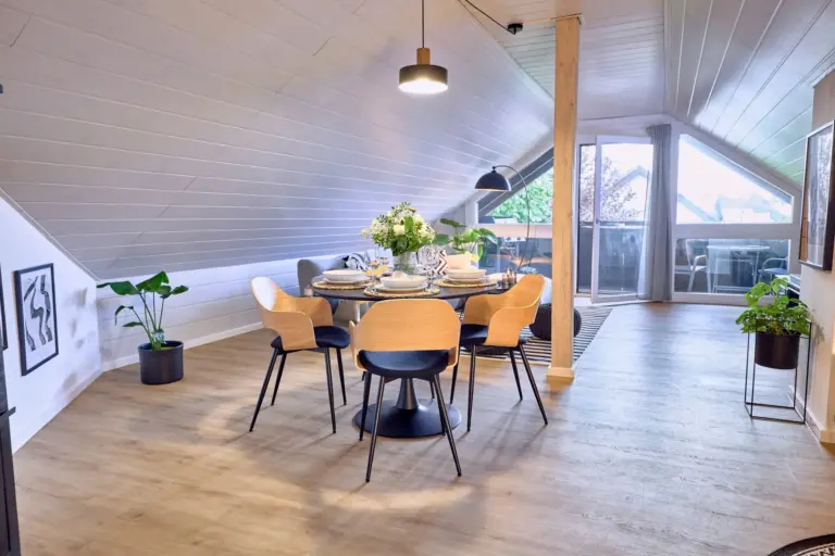 Bright dining area with balcony access at Stay Eden AMBER GLOW