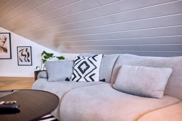 Comfortable sofa with decorative pillows in the living room at Stay Eden AMBER GLOW