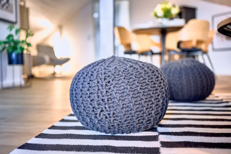 Decorative knitted poufs in the living room at Stay Eden AMBER GLOW