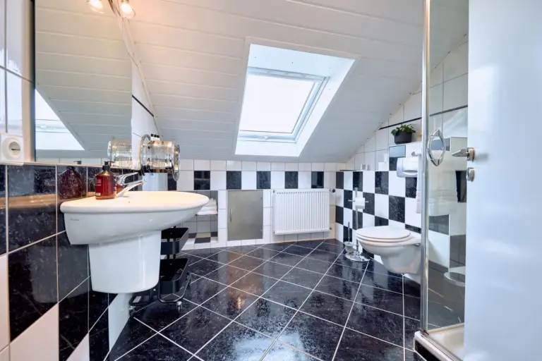 Bright bathroom with shower and skylight at Stay Eden AMBER GLOW