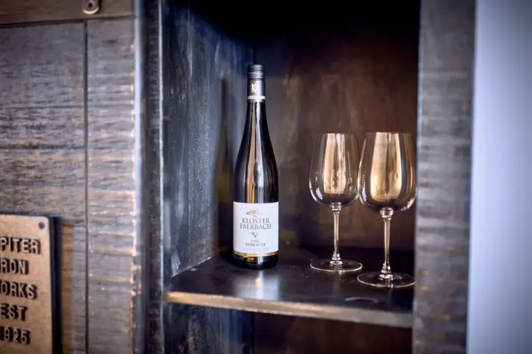 Wine bottle and glasses in dining area at Stay Eden AMBER GLOW