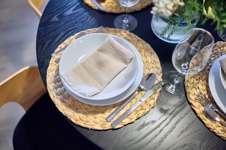 Table setting with plates and wine glasses at Stay Eden AMBER GLOW