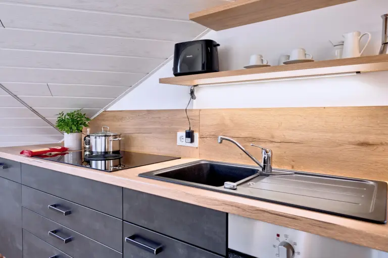 Kitchen with cooktop sink and toaster at Stay Eden AMBER GLOW