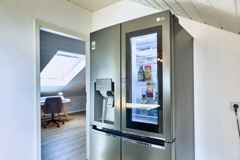 Side-by-side fridge with water dispenser in kitchen at Stay Eden AMBER GLOW