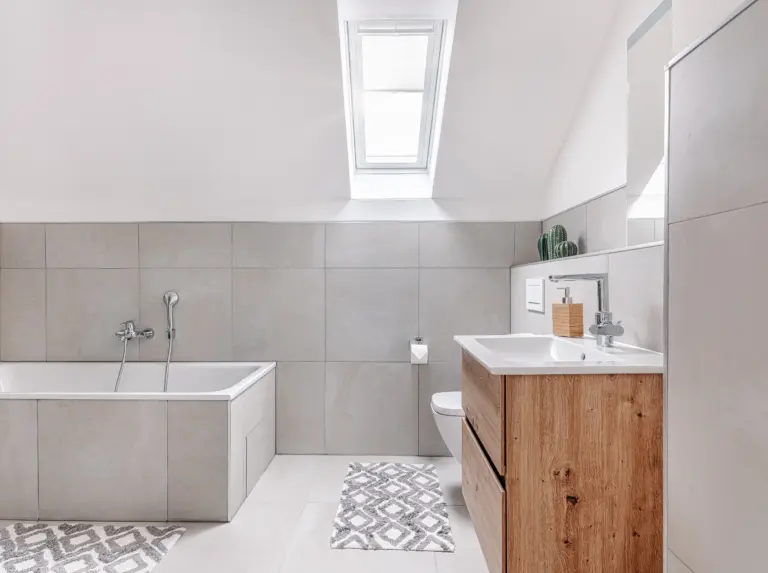 Bright bathroom with bathtub, shower and vanity at PEARL SILVER