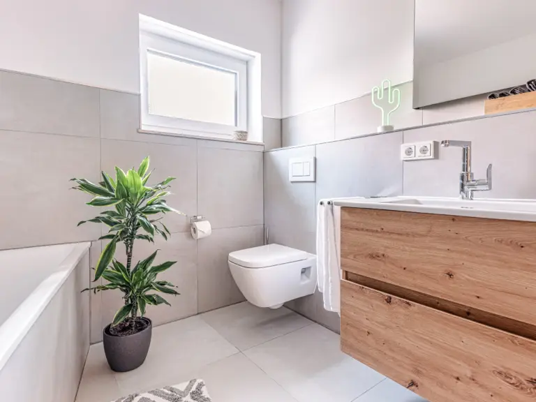 Modern bathroom with vanity and toilet at PEARL WHITE