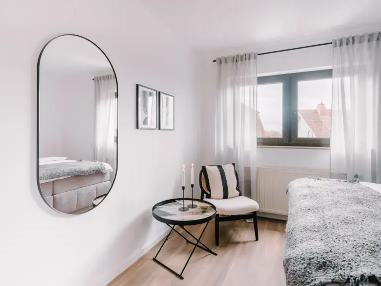 Seating area and mirror in the RUBY RED master bedroom