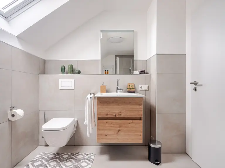 Modern bathroom vanity and wall-mounted toilet at PEARL SILVER