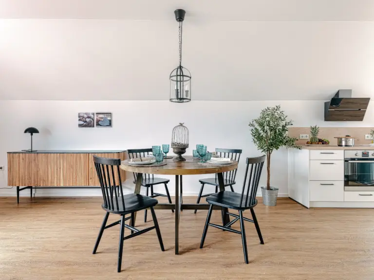 Bright dining area with round table and seating for four at PEARL SILVER