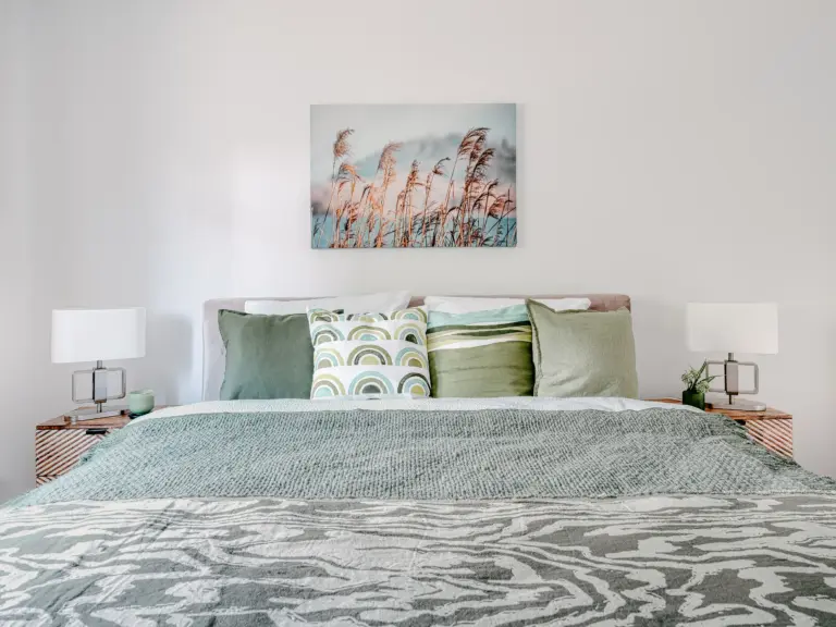 King-size bed with decorative pillows at PEARL WHITE