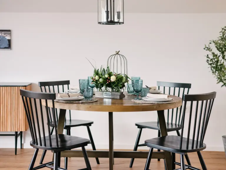 Round dining table set for four at PEARL SILVER