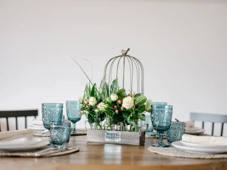 Floral centerpiece and decorative glassware on the dining table at PEARL SILVER