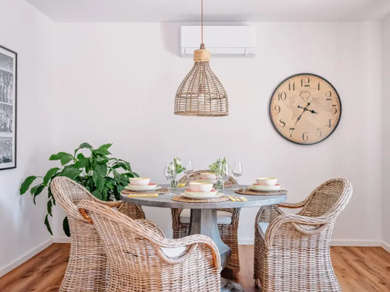 Set dining table with four wicker chairs at PEARL WHITE