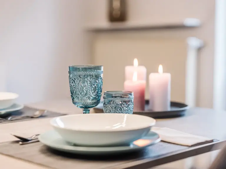 Table setting with plates and glasses in the dining room at RUBY RED