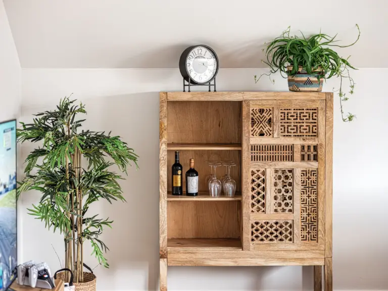 Wooden cabinet with decorative details in the living room at PEARL SILVER