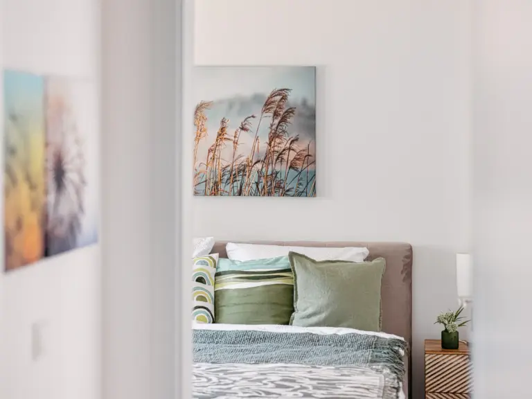 View into the master bedroom with king-size bed at PEARL WHITE
