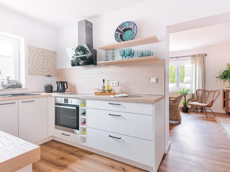 Fully equipped modern kitchen with side-by-side fridge at PEARL WHITE