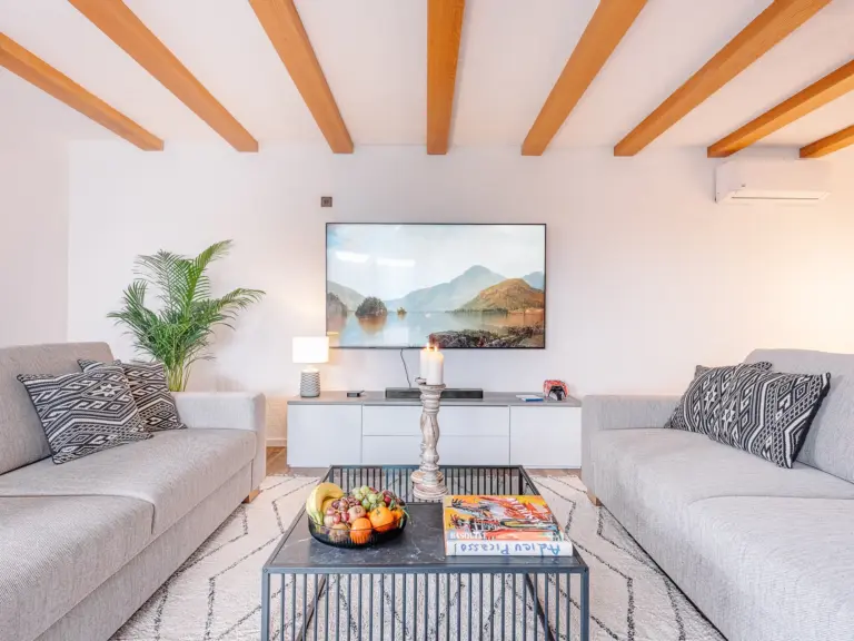Modern living room with sofas and large Smart TV at RUBY RED