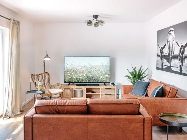 Spacious living room with sofas and TV at PEARL WHITE