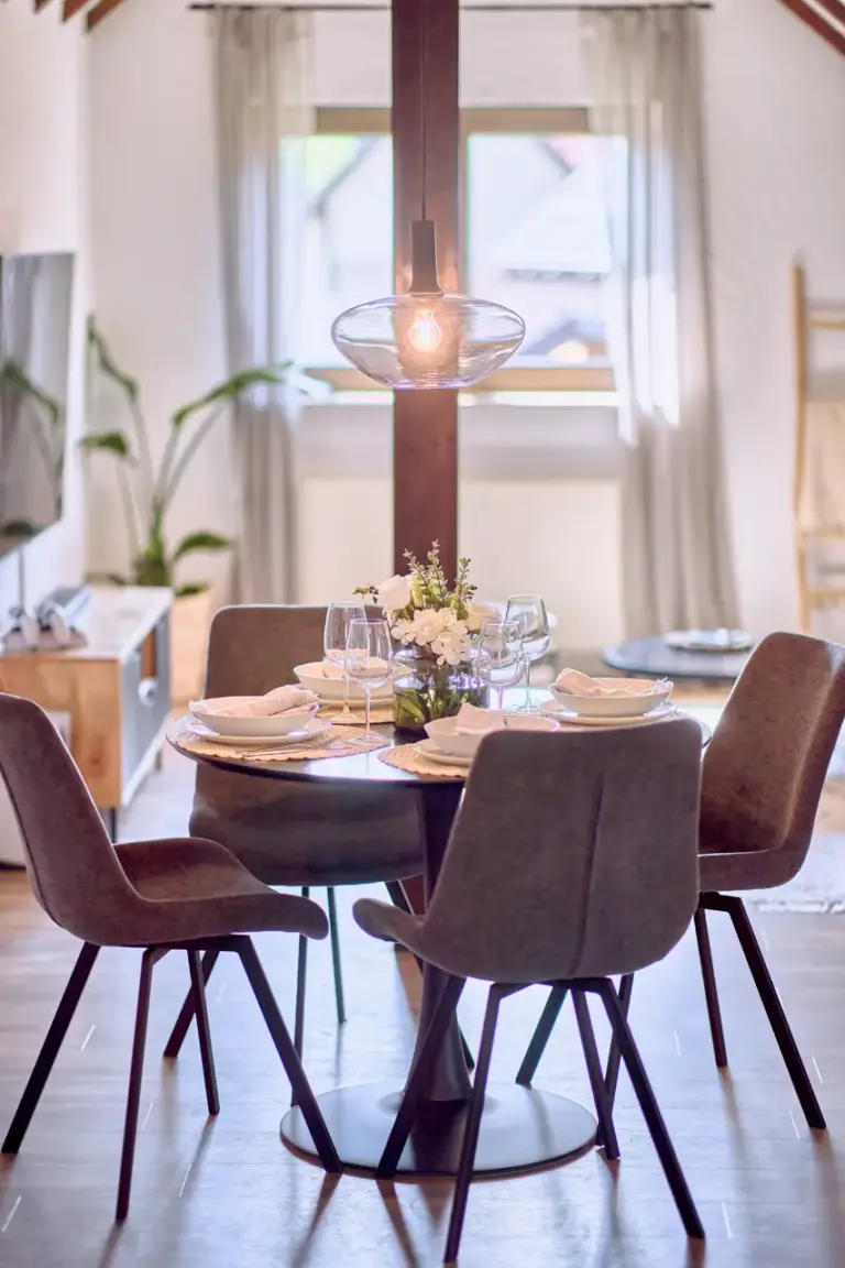 Dining area with round table and four chairs at RUBY NOIR