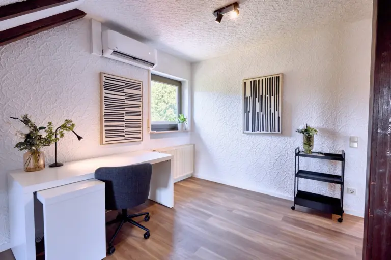 Spacious dedicated workspace with desk and office chair at RUBY NOIR