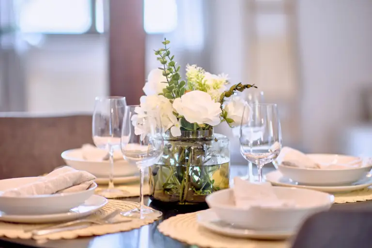 Set dining table with floral centerpiece at RUBY NOIR