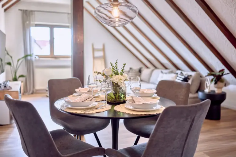 Set dining table with living area in the background at RUBY NOIR