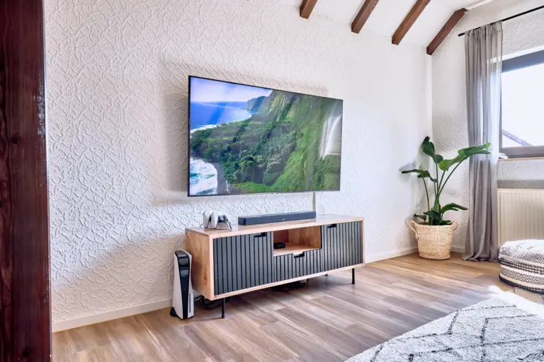 TV, soundbar and PlayStation 5 entertainment setup at RUBY NOIR