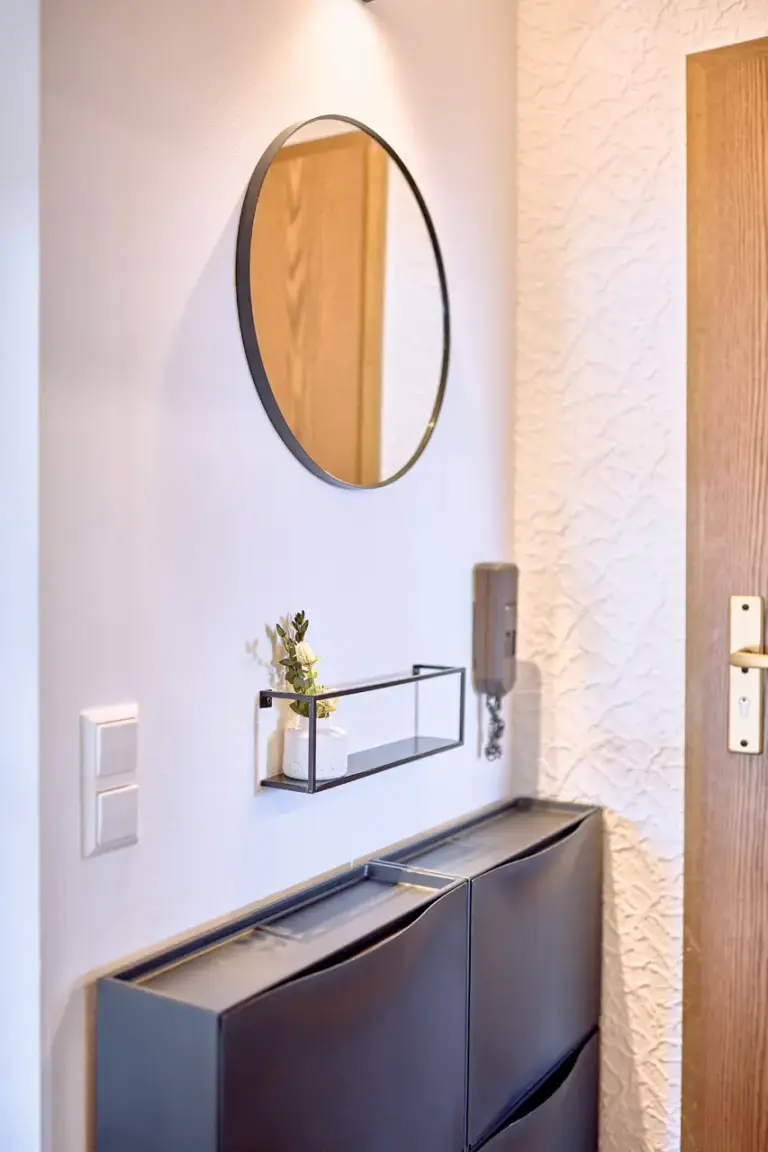 Modern entryway with mirror and storage at RUBY NOIR