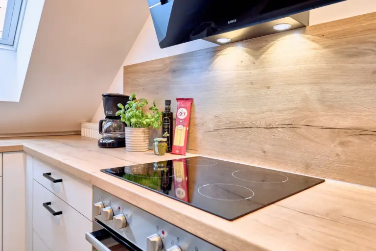 Modern cooktop and coffee maker in the kitchen at RUBY NOIR