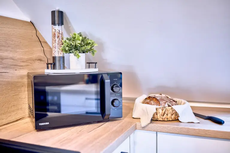 Microwave and kitchen counter at RUBY NOIR