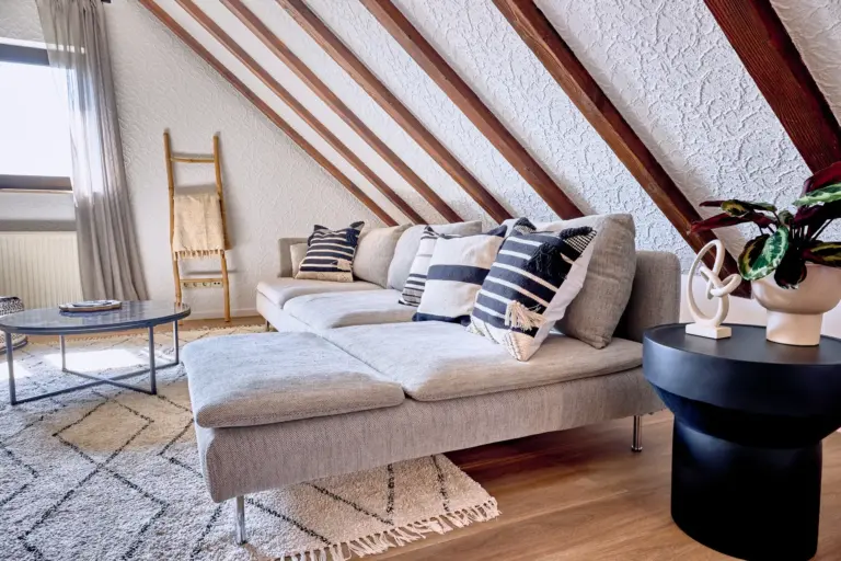 Comfortable living room with sectional sofa and exposed wooden beams at RUBY NOIR