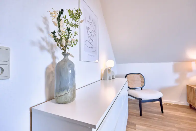 White dresser and modern decor in the master bedroom at RUBY NOIR