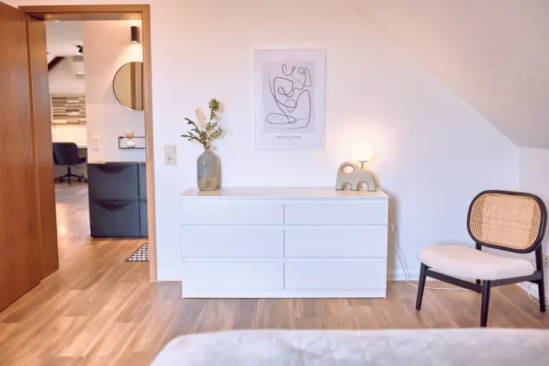 Dresser and seating area in the master bedroom at RUBY NOIR