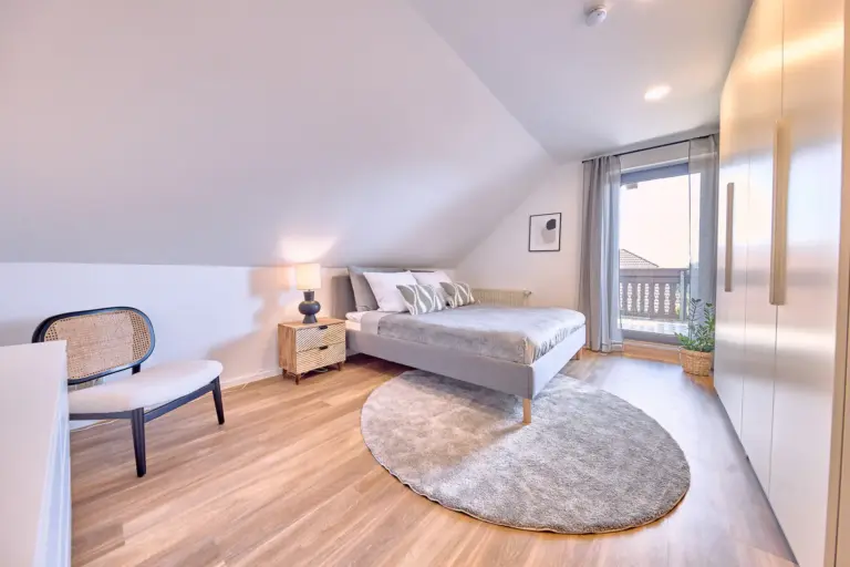 Master bedroom with king-size bed and wardrobe at RUBY NOIR