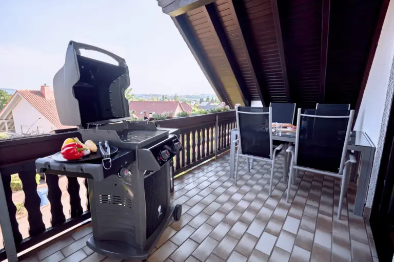 Private balcony with gas grill and outdoor dining area at RUBY NOIR