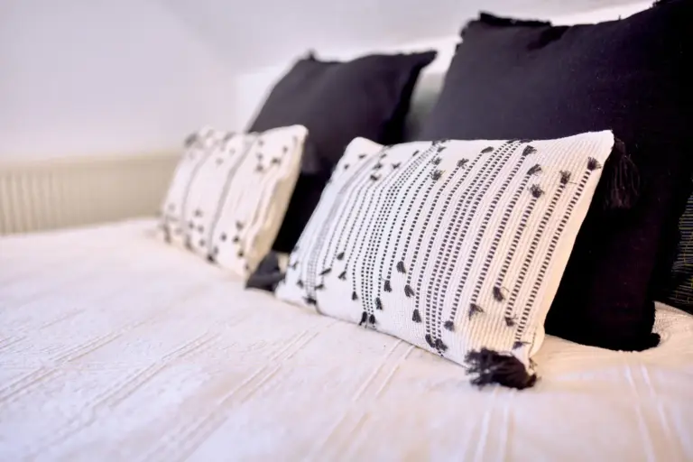 Decorative pillows and bedding in the second bedroom at RUBY NOIR