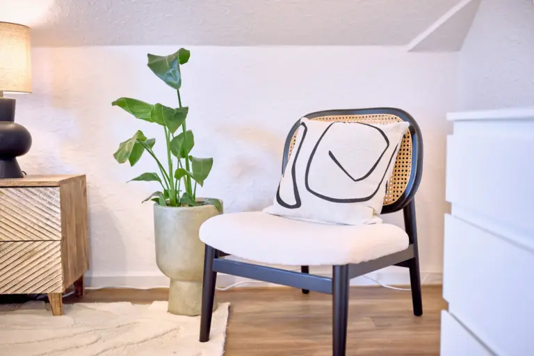 Comfortable chair and plant in the second bedroom at RUBY NOIR