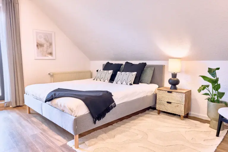 Second bedroom with queen-size bed at RUBY NOIR