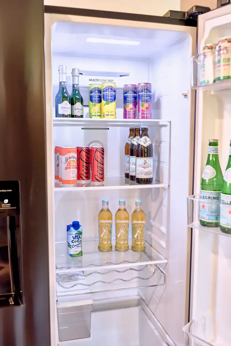 Open side-by-side fridge with beverages at RUBY NOIR