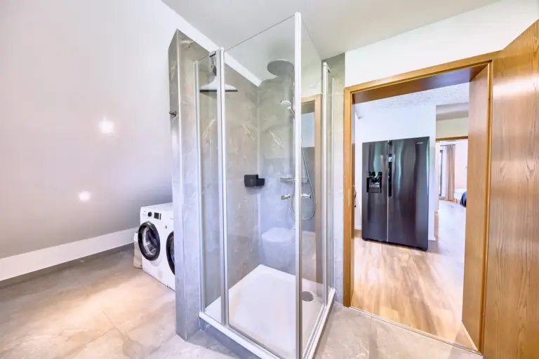 Modern glass-enclosed shower in the bathroom at RUBY NOIR