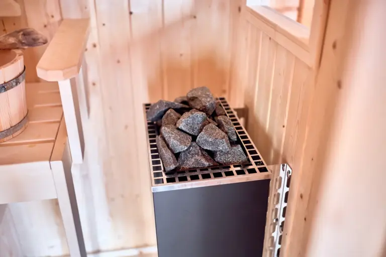 Sauna heater with stones in the private sauna for RUBY RED and RUBY NOIR
