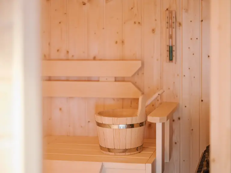 Wooden sauna benches and heater at RUBY RED and RUBY NOIR